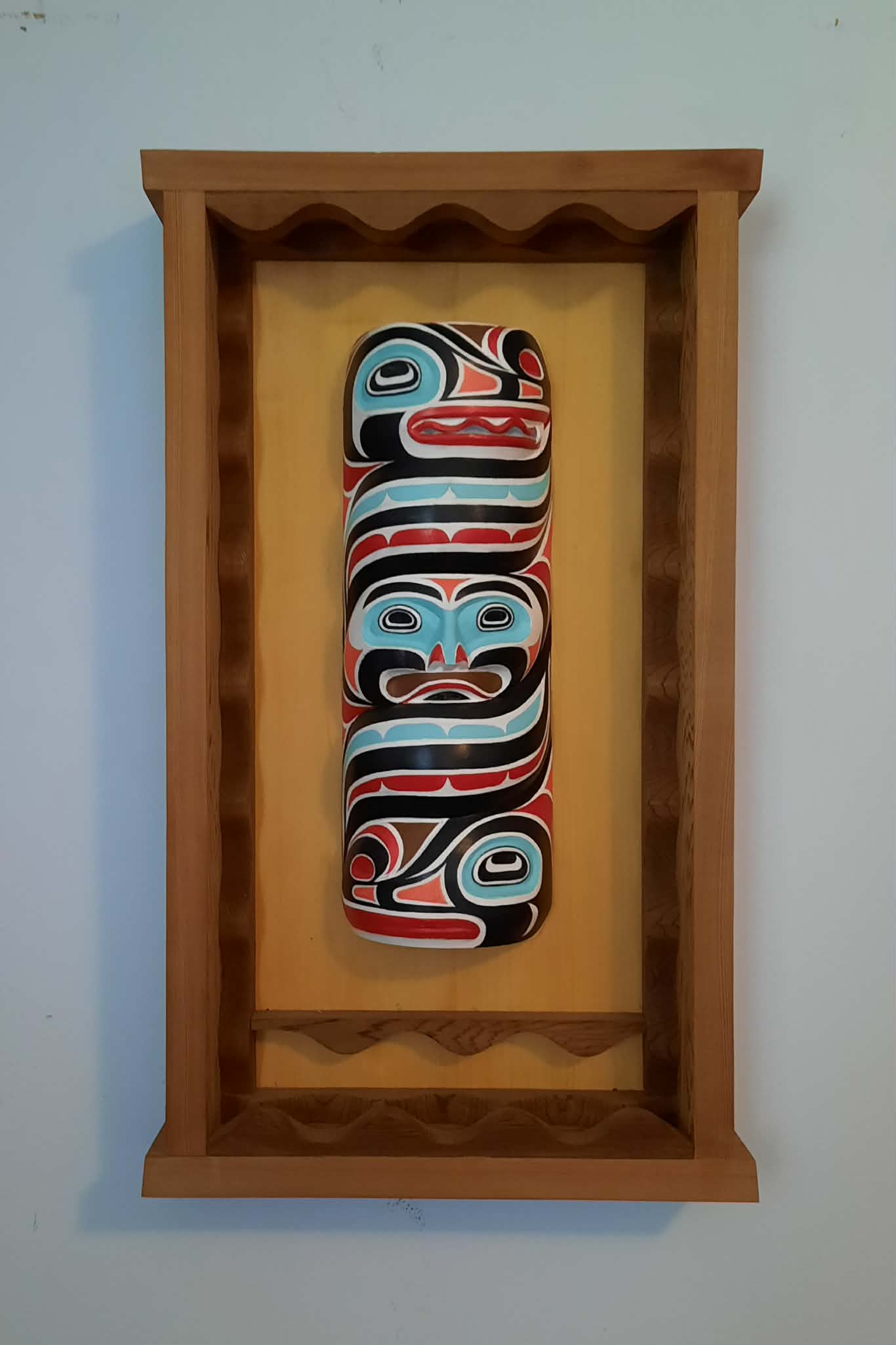 Framed carved totem panel in formline design